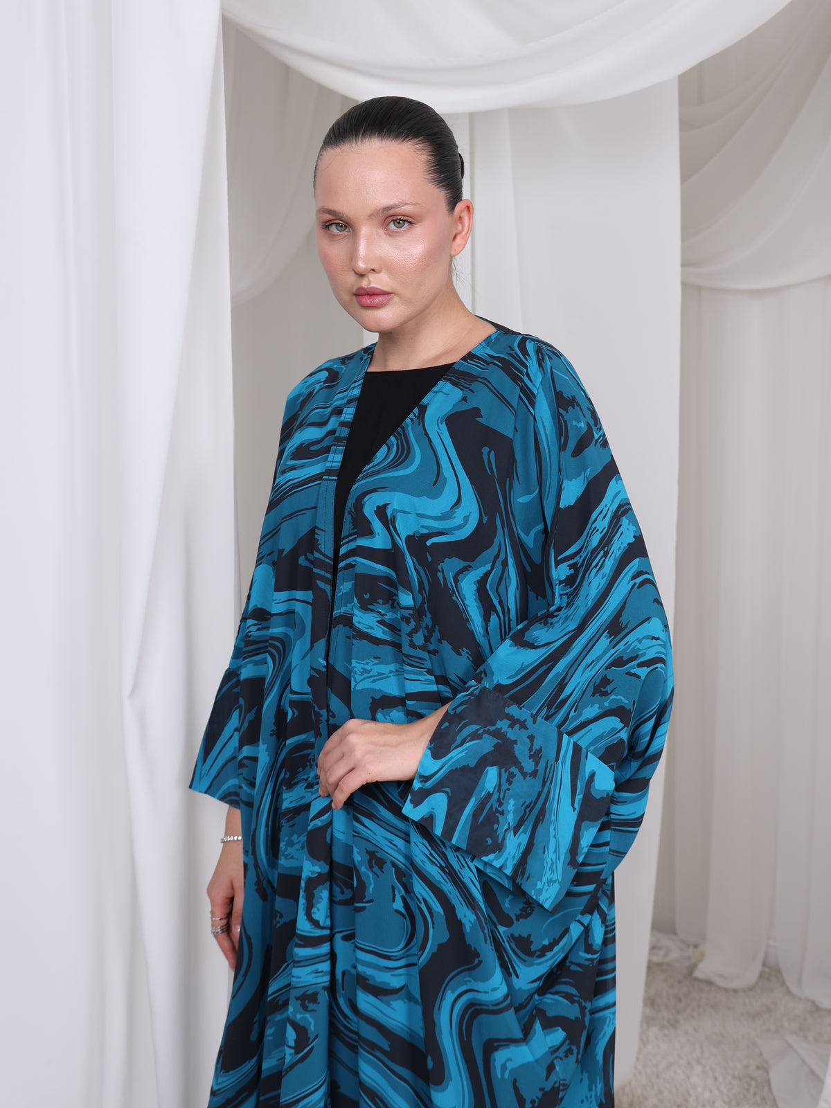 Close-up of the wave-inspired print on The Wave blue abaya