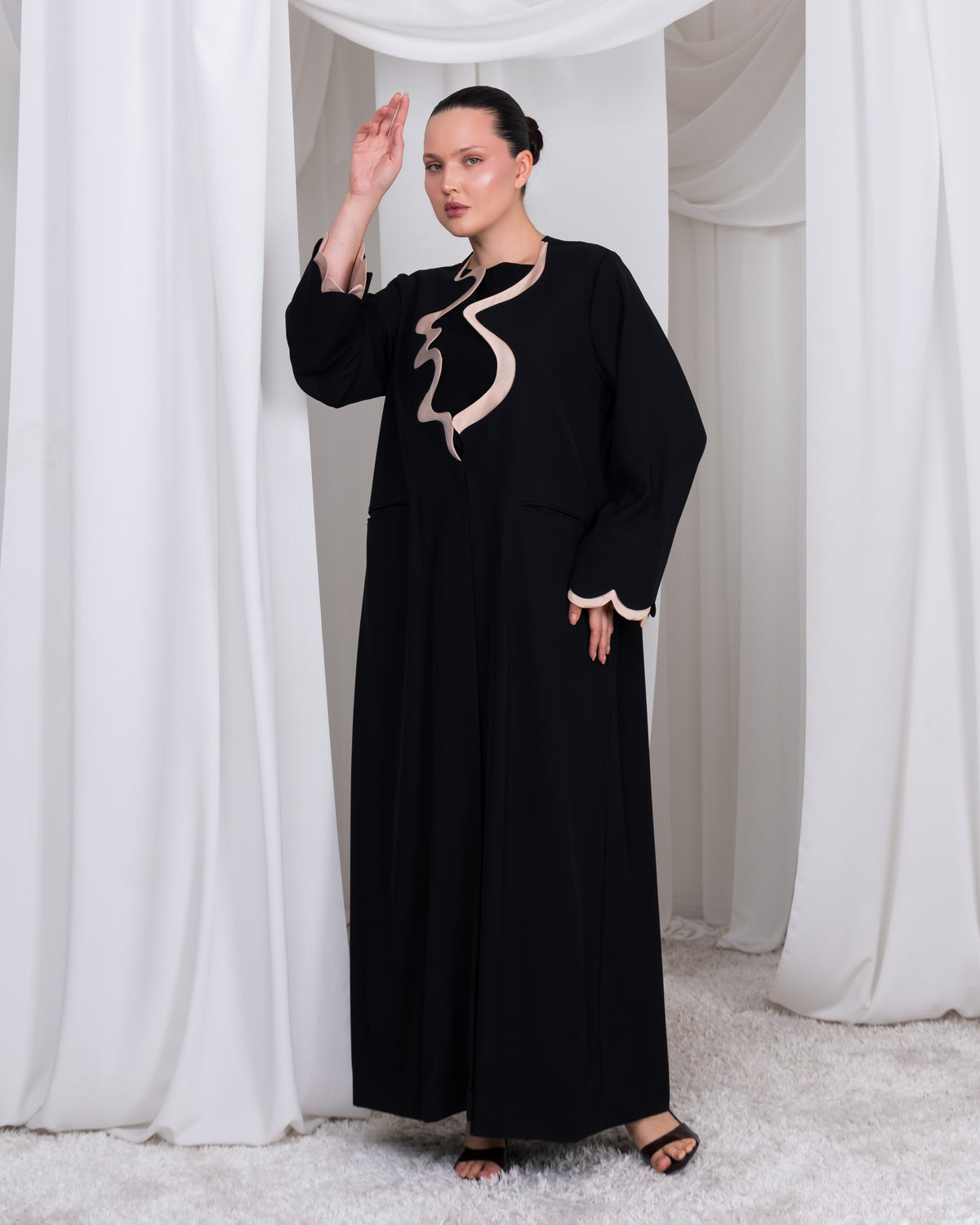 Side view of The Sovereign Flow black luxury abaya with flowing architectural front detail